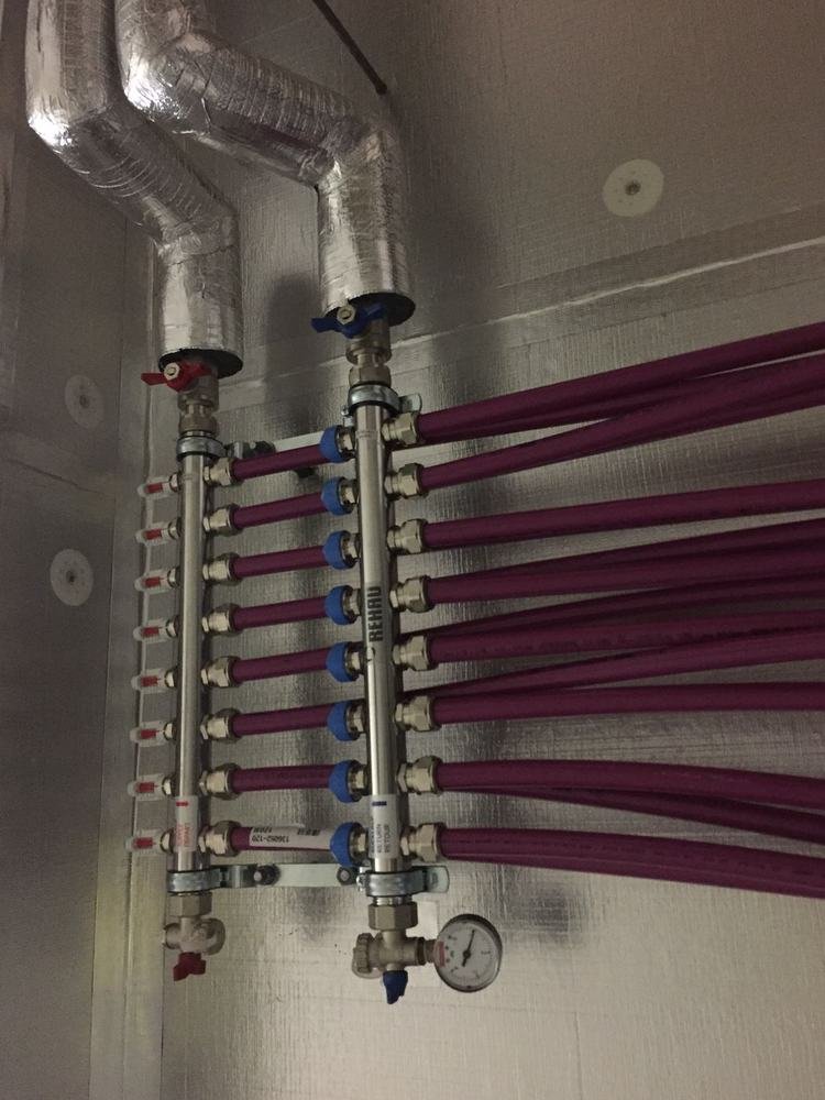 REHAU manifold close-up showing zone controls and circuit connections, Euroheat installation