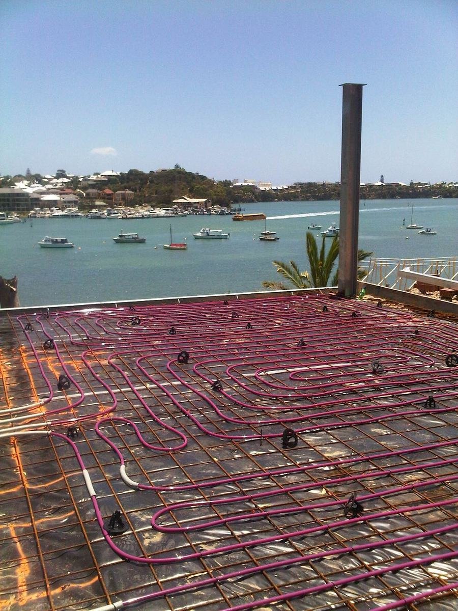 Hydronic pipe loops laid out on a slab before the concrete pour